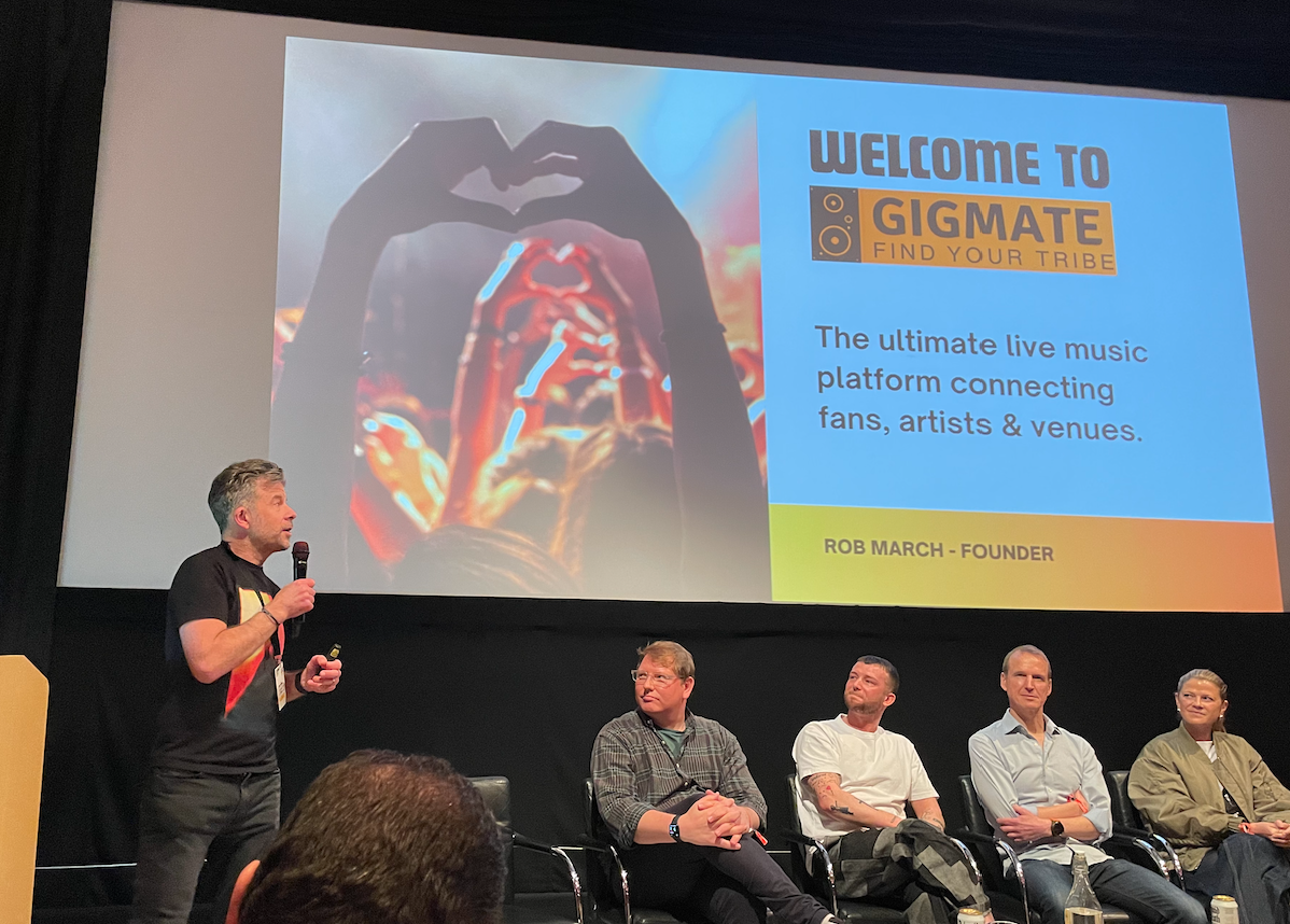 GigMate founder presenting the platform on stage at a live music event